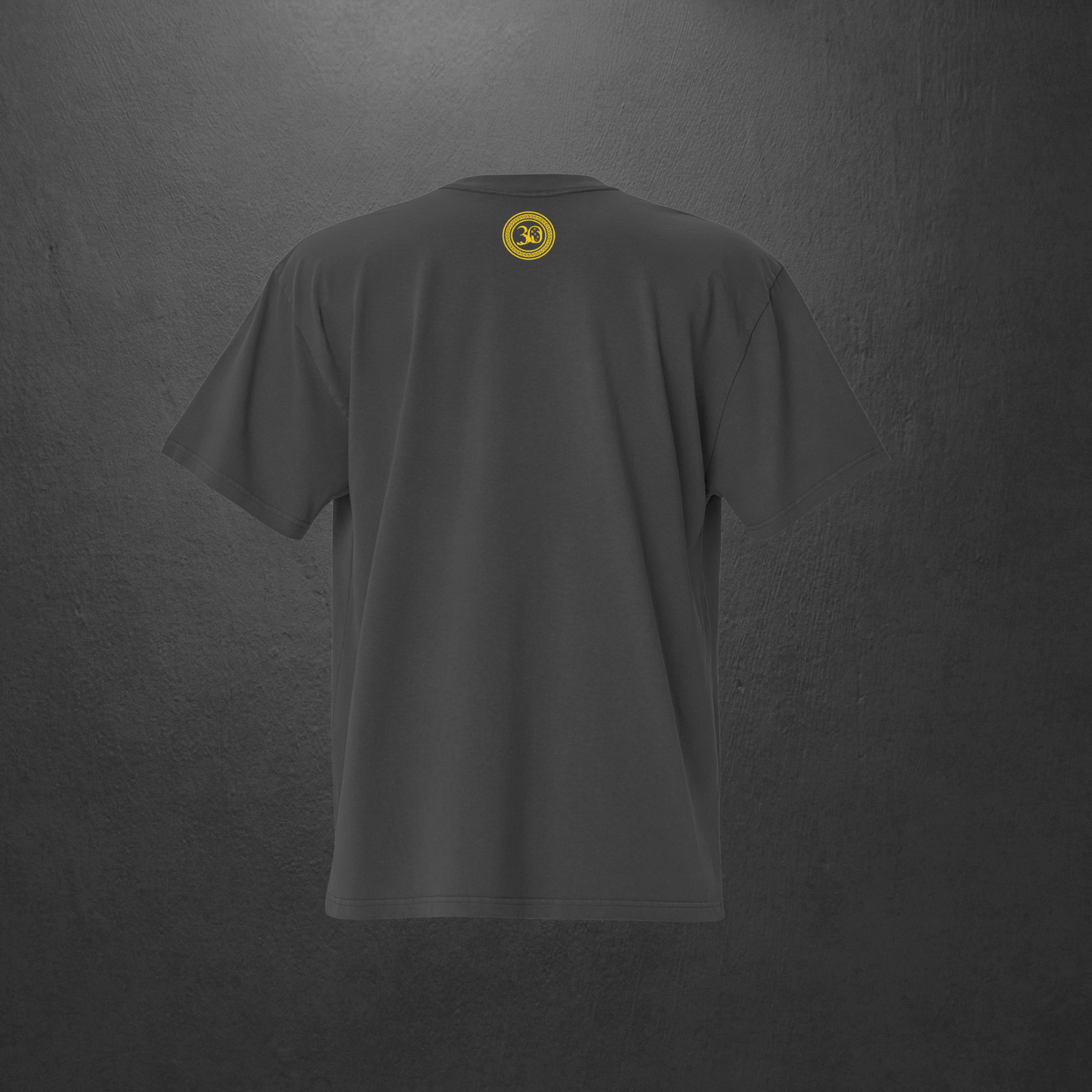 Gray t-shirt with a yellow logo on the back against a dark gray background